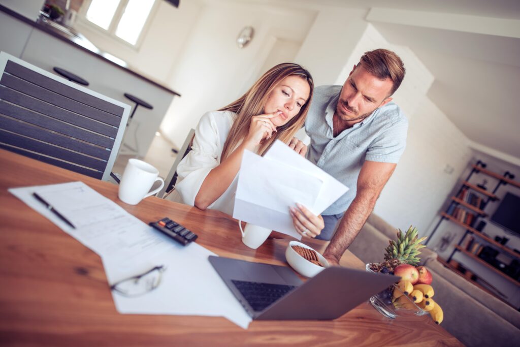 A couple stressed out while looking over their back taxes and in need of a Washington tax attorney.