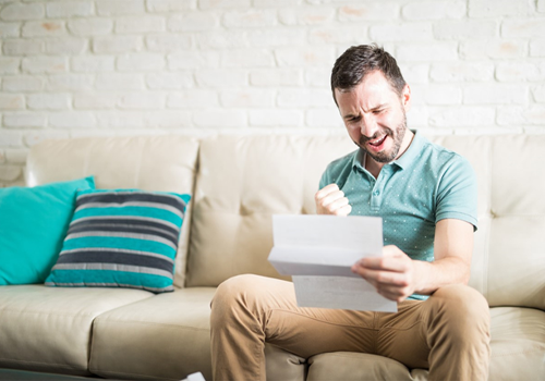 A man excited that he received a letter from the IRS that his penalty removal was approved.